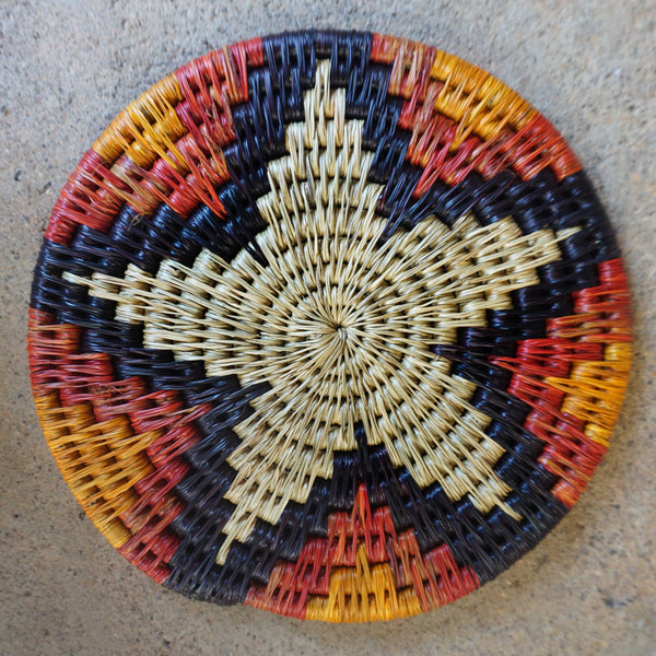 "Handwoven African potstands: Add a pop of color to your kitchen with traditional craftsmanship. Vibrant colors and patterns elevate your countertop. Sturdy materials protect against hot cookware. Experience the beauty of African artistry in your meal prep routine."